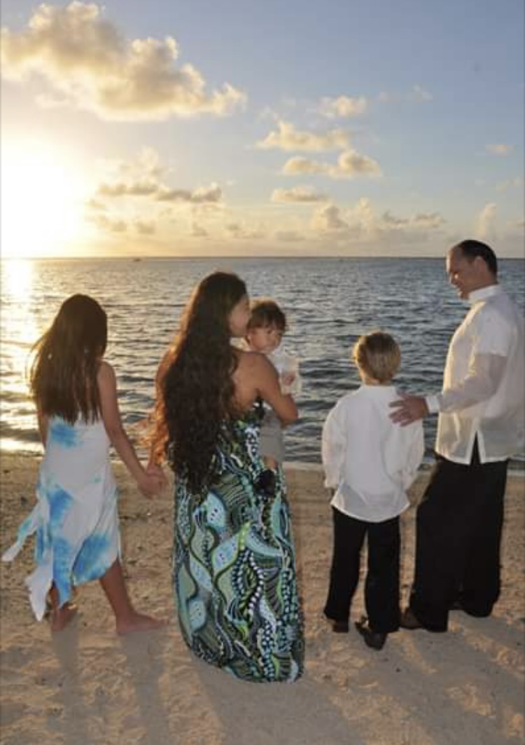 Family by the ocean at sunset